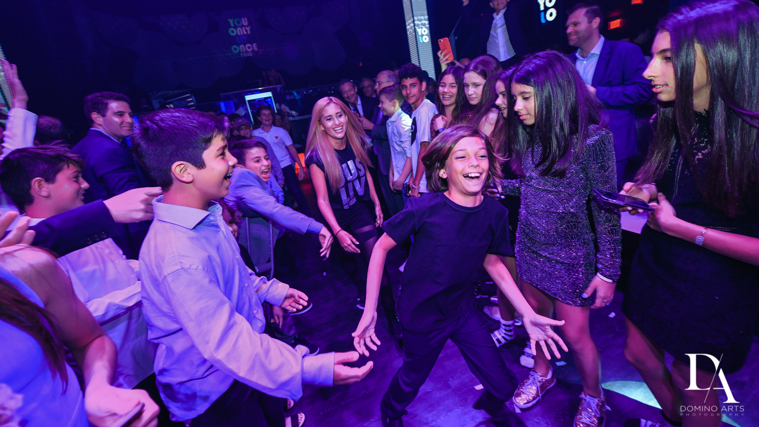 fun siblings entrance at Nightclub Bat Mitzvah at LIV in Fontainebleau Miami by Domino Arts Photography