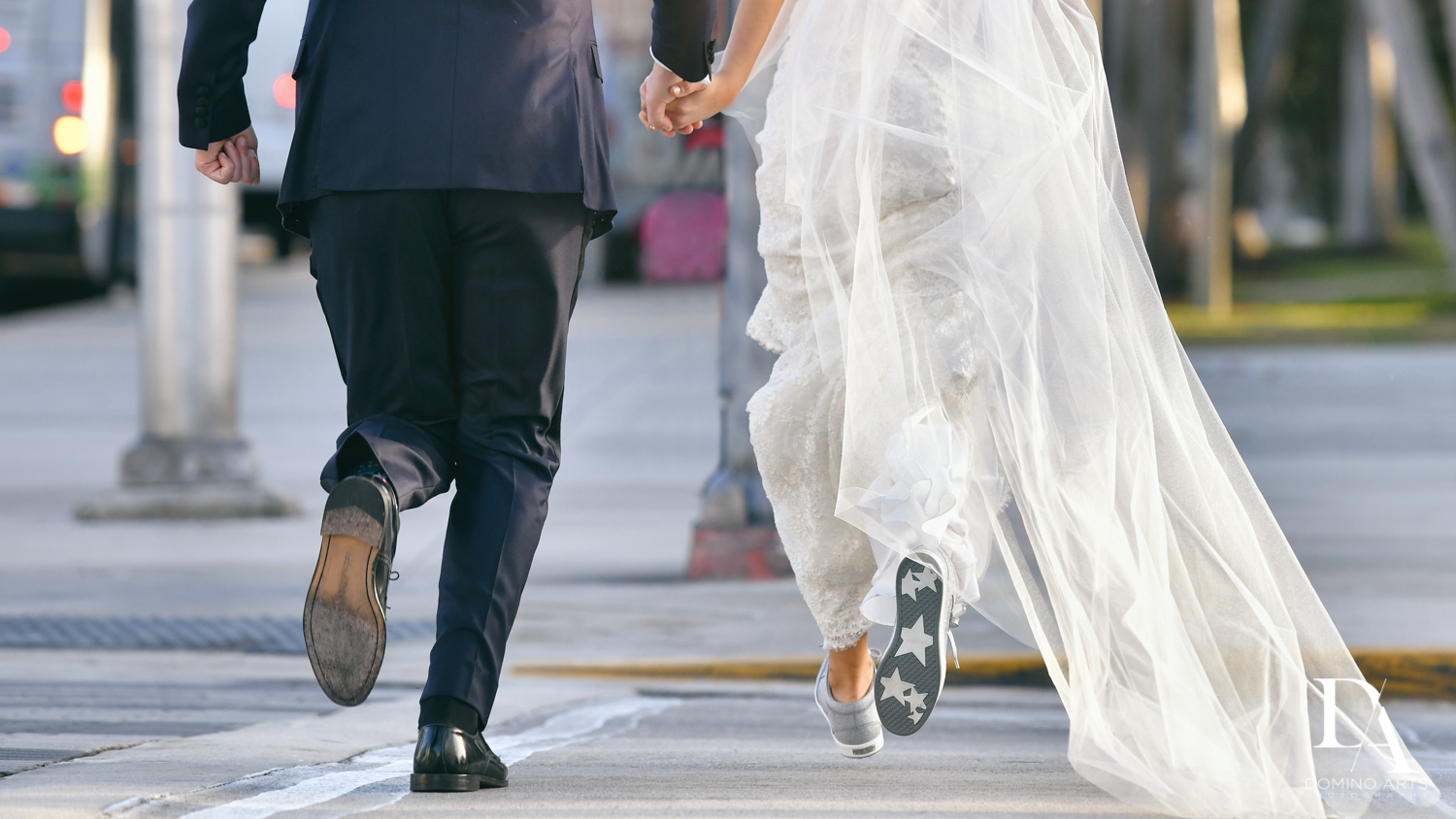 bride and groom running across street at Classic Miami Beach Wedding at Temple Emanu-El and Emanuel Luxury Venue by Domino Arts Photography