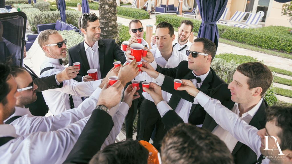 groomsmen at Romantic Ocean Side Wedding at Eau Palm Beach by Domino Arts Photography