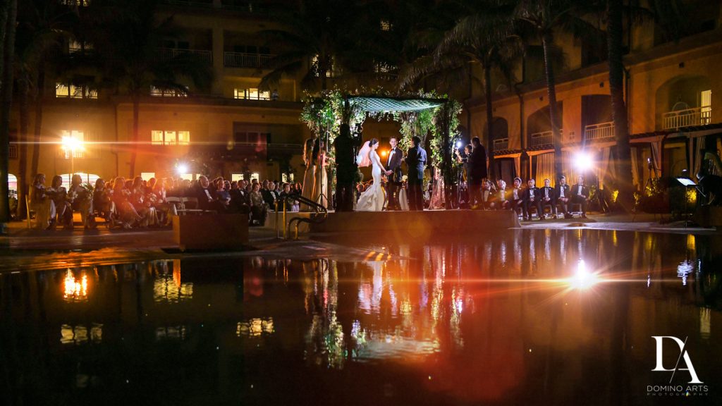 pool ceremony at Romantic Ocean Side Wedding at Eau Palm Beach by Domino Arts Photography